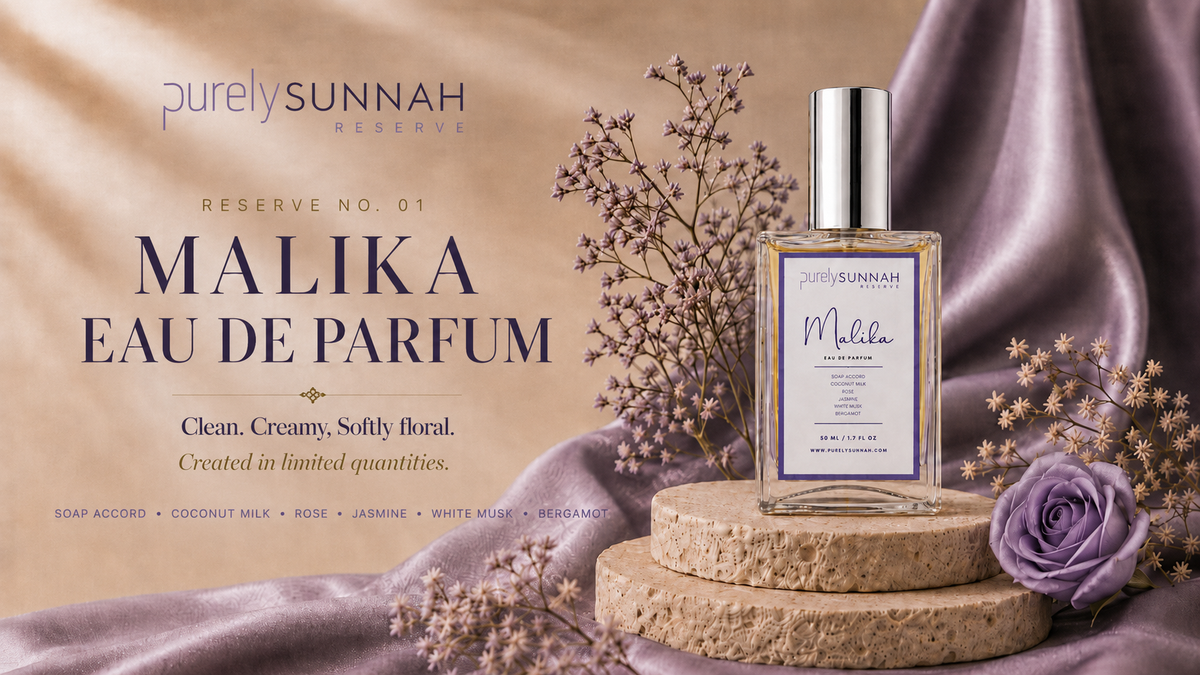 Purely Sunnah Reserve No. 01 Malika Eau De Parfum bottle displayed on stacked stone blocks with dried flowers and a purple rose against a draped satin background.